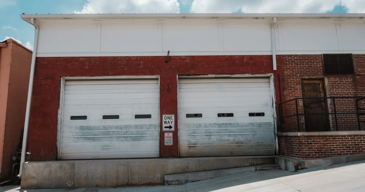 Brick industrial building with two roller garage doors