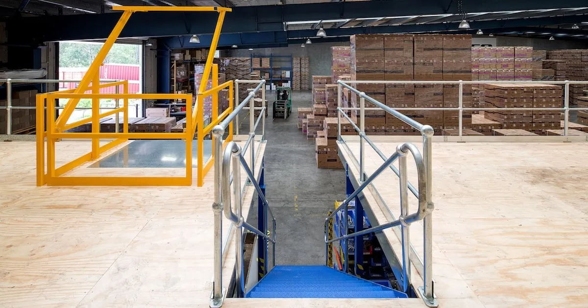 Warehouse mezzanine platform with stairs and safety railings