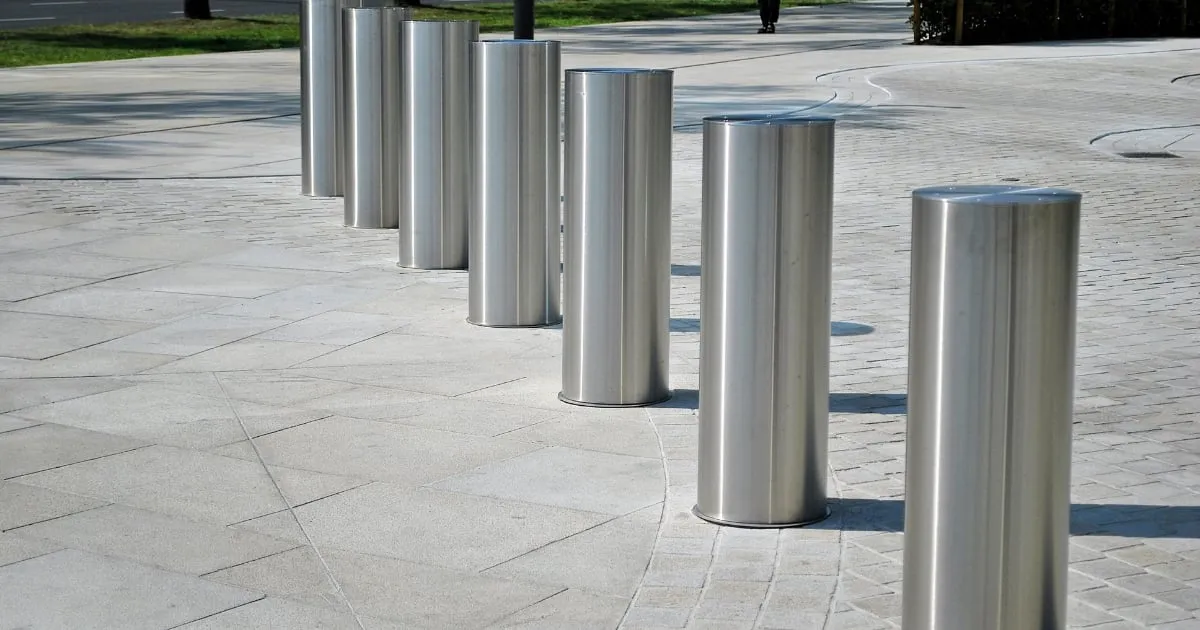 Stainless steel bollards lining paved pedestrian walkway