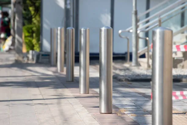 Stainless steel bollards lining urban footpath