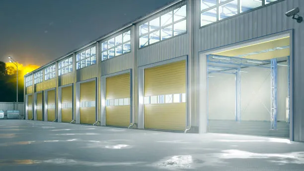 Modern warehouse with multiple roller doors at dusk
