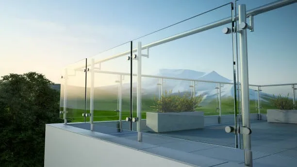 Modern glass balustrade overlooking mountains at sunset