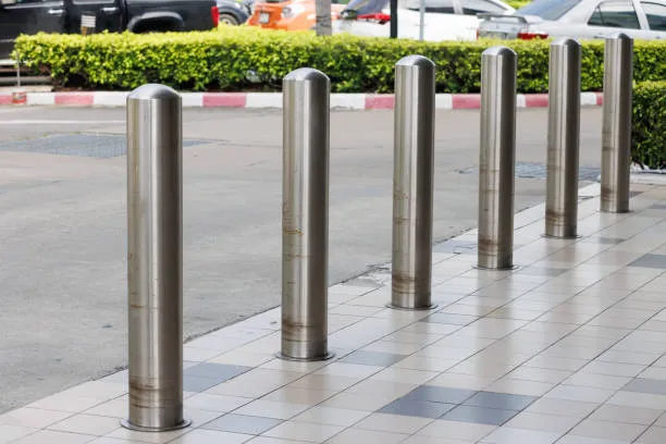 Stainless steel bollards lining footpath near street