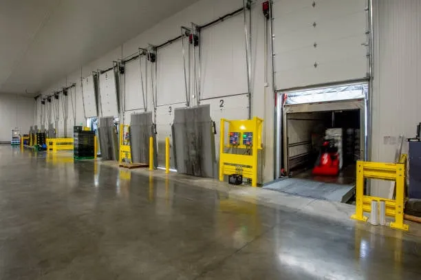A row of numbered industrial loading docks inside a clean warehouse