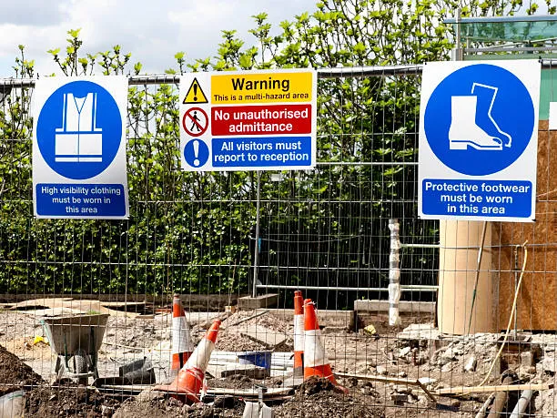 Construction site with safety warning and PPE signs