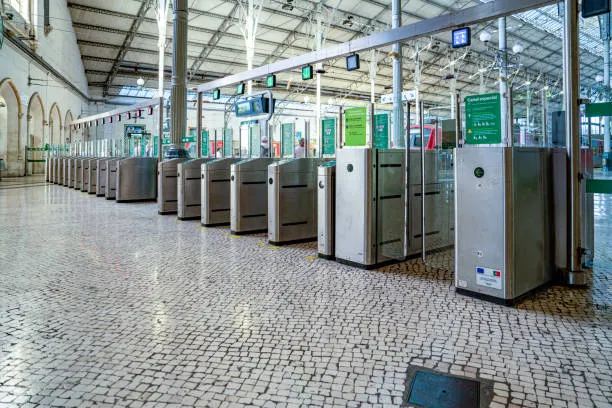 Empty train station ticket gates inside large hall