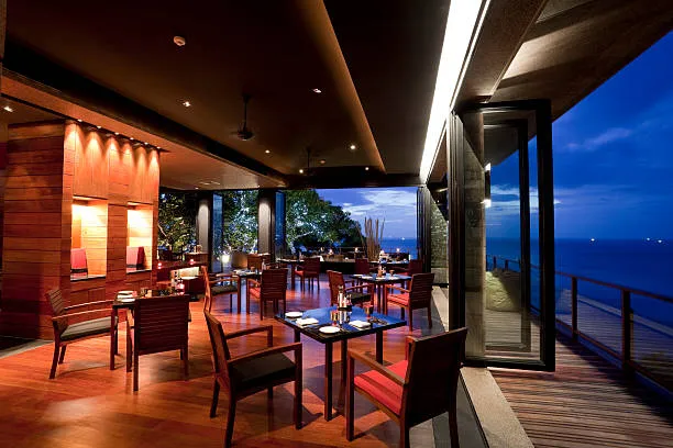 Open-air seaside restaurant terrace at dusk