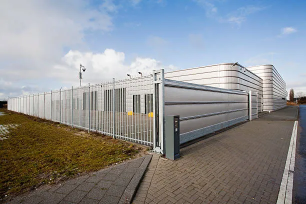 Industrial building with metal security fence and gate